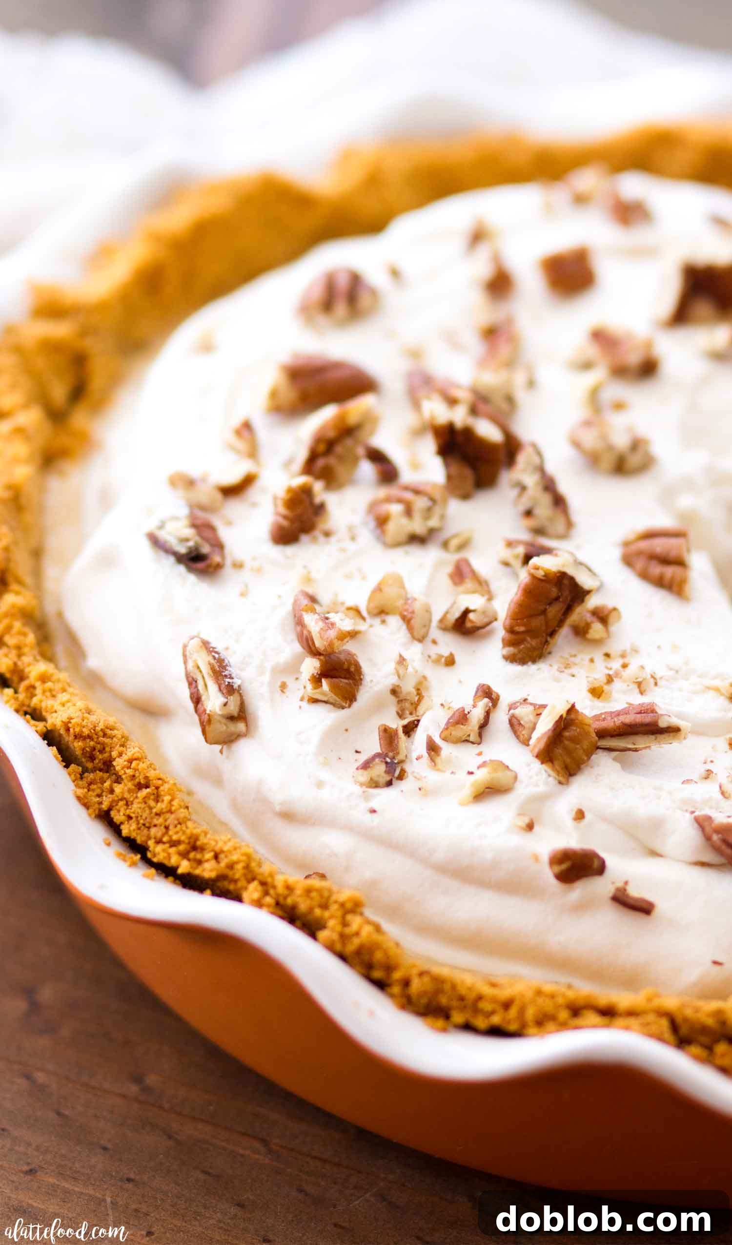 The finished Easy Pecan Caramel Cheesecake, generously drizzled with Torani Caramel and White Chocolate sauces, and topped with crunchy pecans.