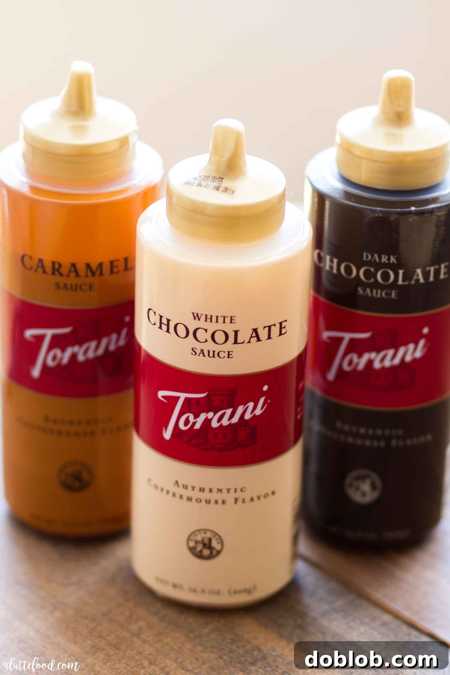 An organized display of various Torani Sauce Bottles, showcasing their elegant packaging and wide selection of flavors, perfect for inspiring home baristas and bakers.