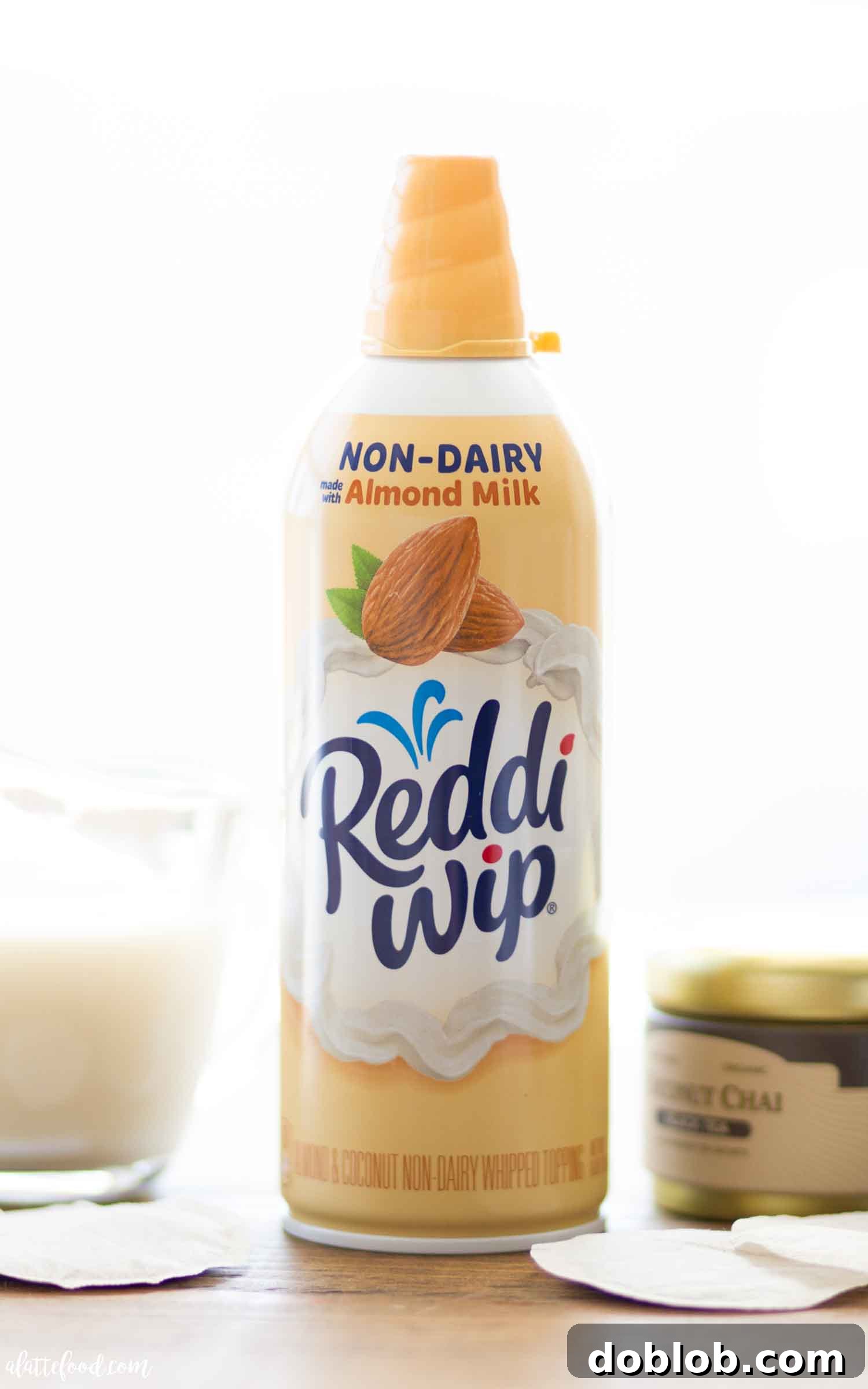 Delicious easy chai latte topped with frothy almond milk and almond whipped cream.